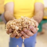 handful-dry-technological-wood-chips-selective-focus-sawdust