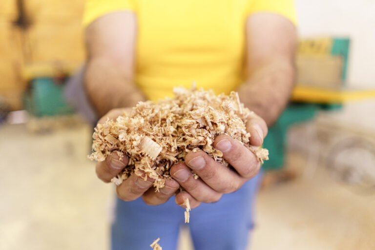 handful-dry-technological-wood-chips-selective-focus-sawdust