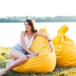 long-shot-beautiful-woman-posing-yellow-beanbag