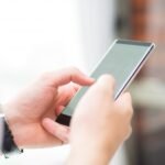 close-up-unrecognizable-man-touching-smartphone-screen_1262-16925