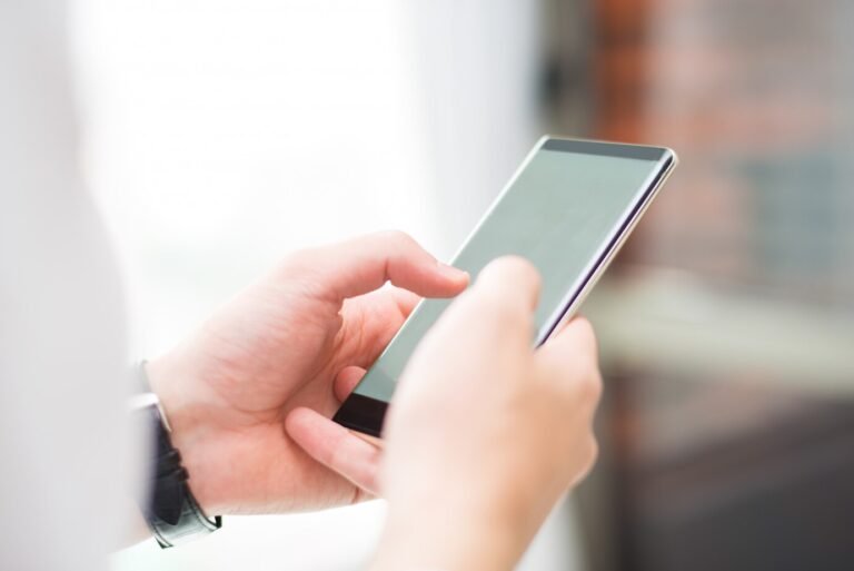 close-up-unrecognizable-man-touching-smartphone-screen_1262-16925