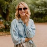 attractive-blond-smiling-woman-walking-park-stylish-outfit_285396-8178