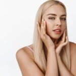 close-up-young-woman-enjoy-touching-her-soft-clean-face-put-moisturizer-cream-lotion-facial-skin-standing-white_176420-40714
