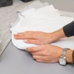 close-up-arranging-clothes_23-2148857484