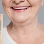 close-up-woman-holding-toothbrush_23-2148803477